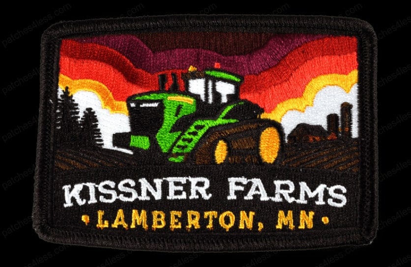 Rectangular embroidered patch with a green tractor on a farm field under a colorful sunset. Text on the patch reads Kissner Farms Lamberton, MN.