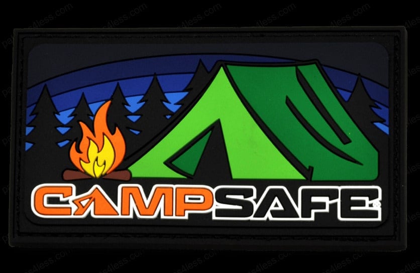 Rectangular PVC patch featuring a green tent and a campfire with trees and a night sky in the background. The text on the patch reads Camp Safe.