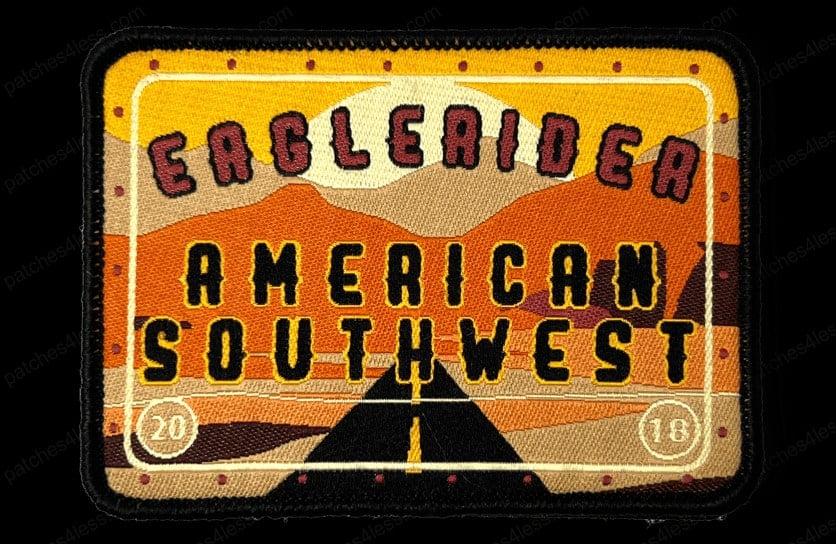 Rectangular woven patch with a desert road and mountain scene under a setting sun. Text on the patch reads EagleRider American Southwest, with the numbers 20 and 18 in the corners.