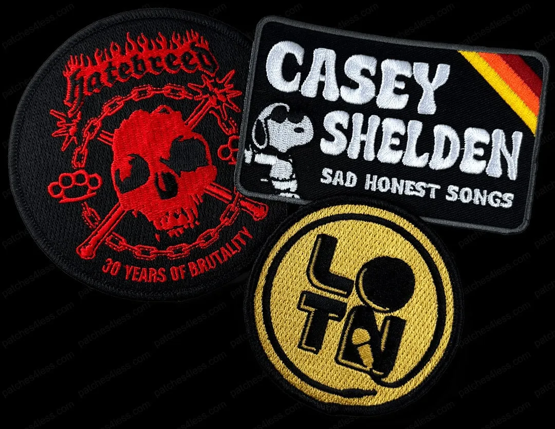 Three band patches. One is a circular patch with a red skull, chain, and brass knuckles with the text 'Hatebreed 30 Years of Brutality', another is a rectangular patch with Snoopy and the text 'Casey Shelden Sad Honest Songs', and the third is a yellow circular patch with the letters 'L' and 'T' surrounding a black circle.