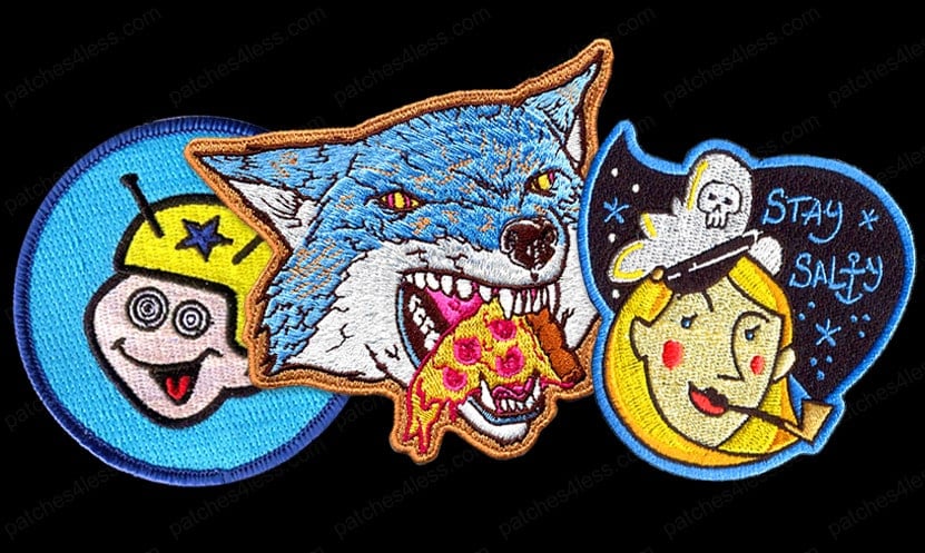 Three funny patches. One is a circular patch with a smiley face wearing a yellow helmet, another features a wolf eating a slice of pizza, and the third shows a moon character with a pipe and the text 'Stay Salty'.