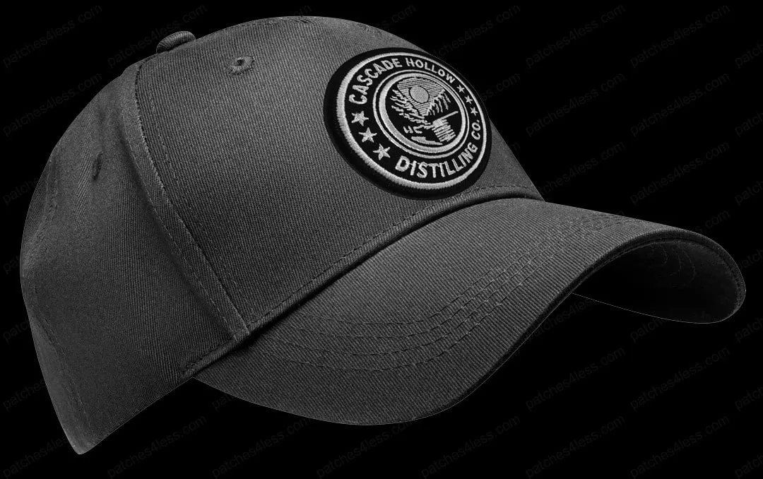 A black baseball cap with a Cascade Hollow Distilling Co. logo patch on the front.