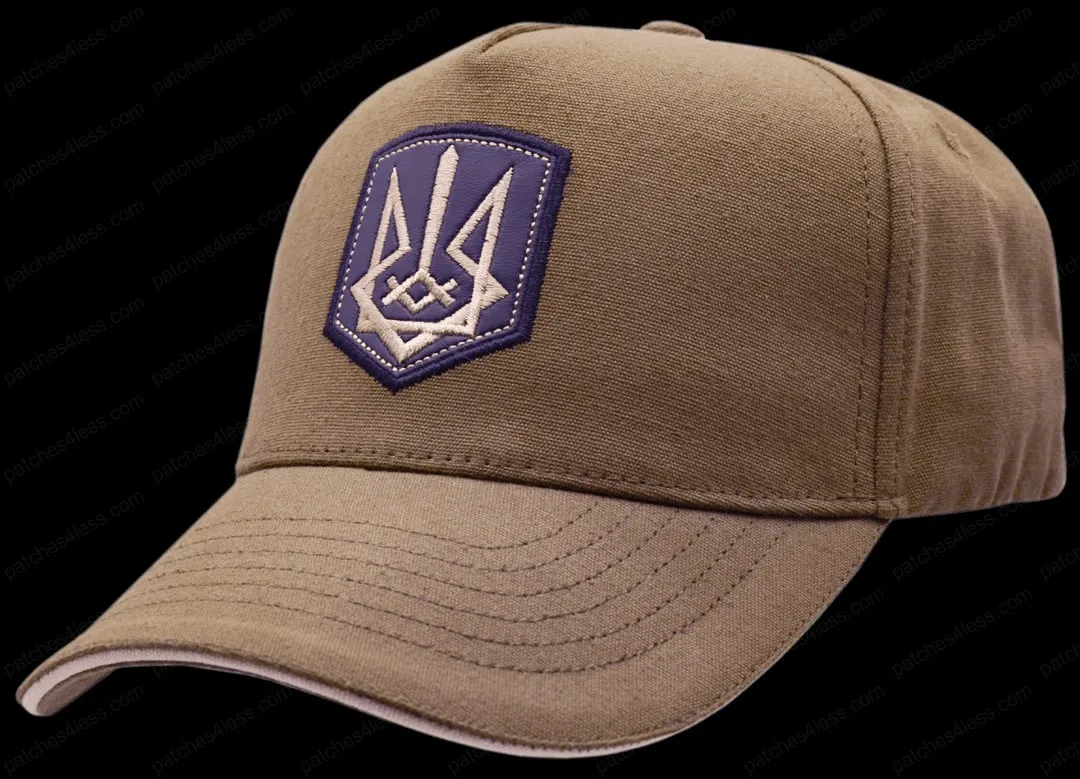 A tan baseball cap with a purple and white embroidered logo on the front.