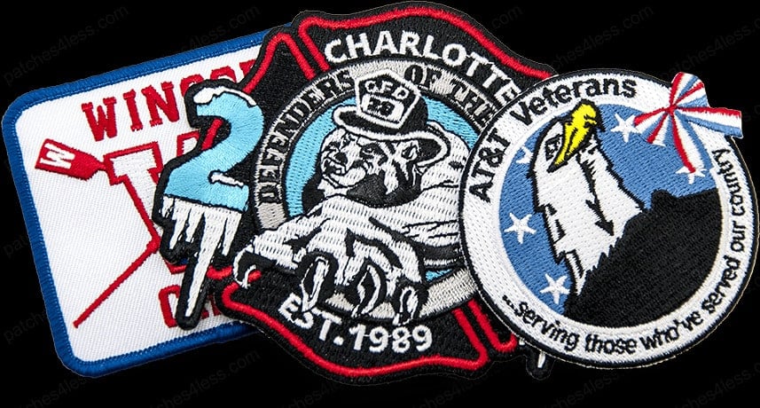 Three iron-on patches. One reads 'Winston' with a large red 'Y', another shows a bulldog with the text 'Charlotte Defenders of the EST. 1989', and the third features an eagle with the text 'AT&T Veterans - serving those who've served our country'.