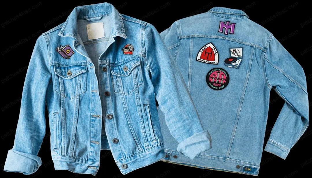 Two denim jackets: one with patches of a book and a helmet on the front, and one with multiple patches including 'Hiker Trash', 'Invasion in Ash', and a record player on the back.