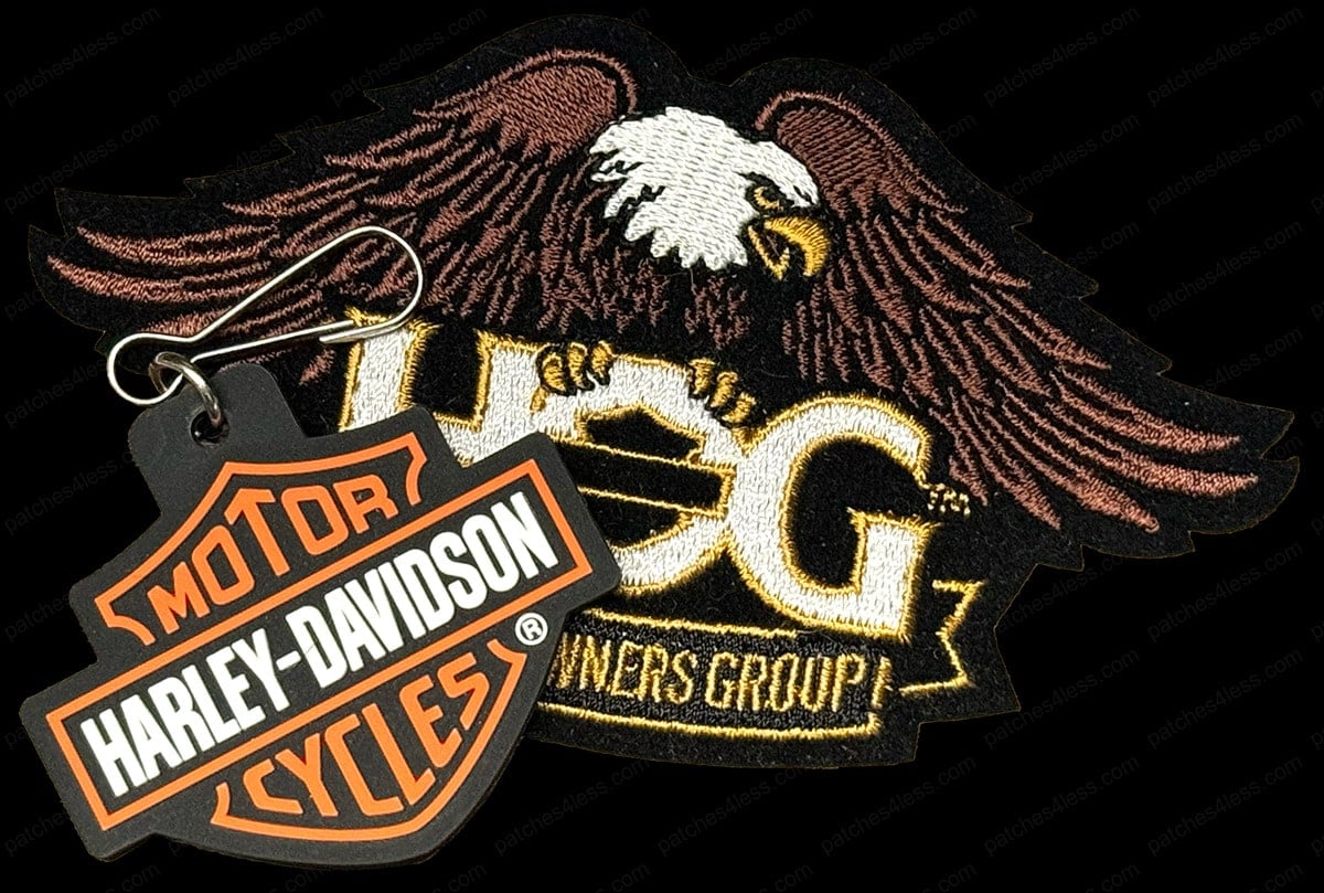 Two motorcycle patches. One features an eagle with the text 'HOG Owners Group' and the other is a Harley-Davidson logo keychain patch with 'Motor Cycles Harley-Davidson'.