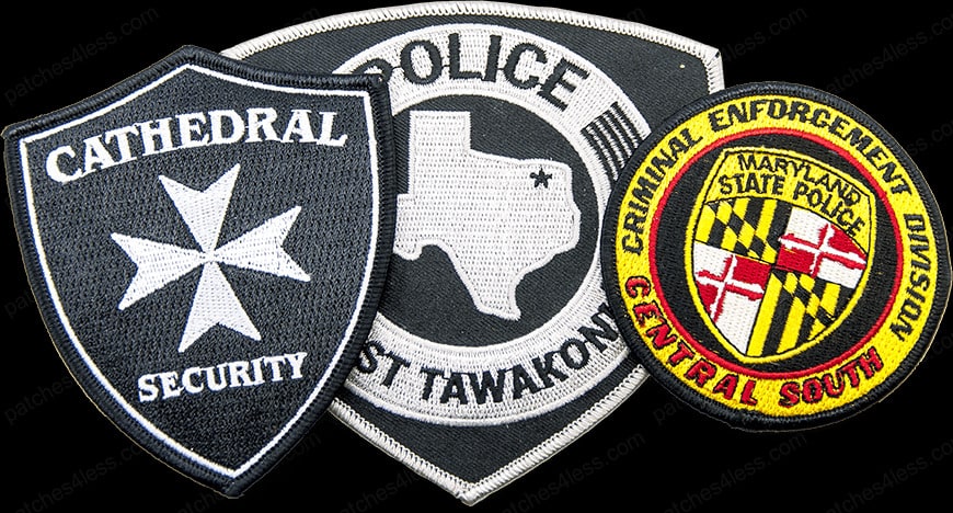 Three police patches. One reads 'Cathedral Security' with a cross emblem, another shows the shape of Texas with 'Police East Tawakoni', and the third is a circular patch with the Maryland flag and the text 'Criminal Enforcement Division Central South Maryland State Police'.